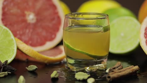 Lime-slice-falls-into-a-glass-cup-with-an-alcoholic-cocktail