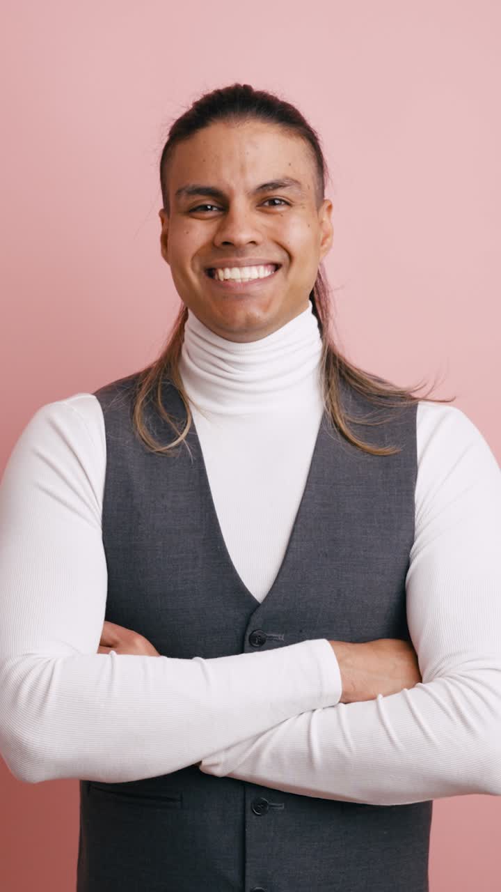 Smiling Man with Crossed Arms Posing in Studio