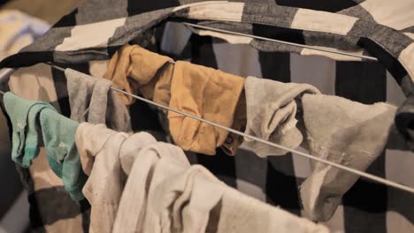 woman hanging clothes on a drying rack