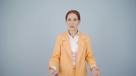 business woman happily speaking to camera.