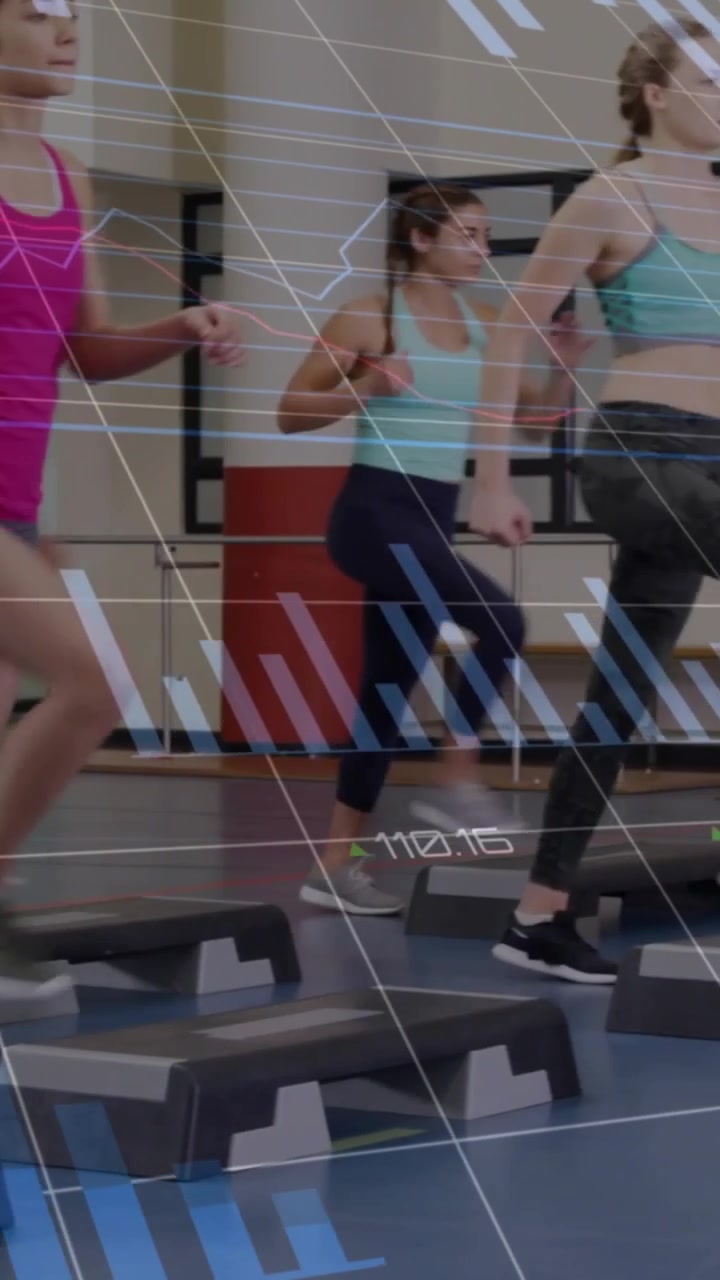Vertical video: Coach cueing class stepping, syncing knees for cardio as overlays tracking motion