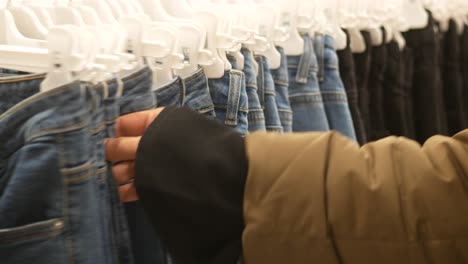 person shopping for jeans in a store