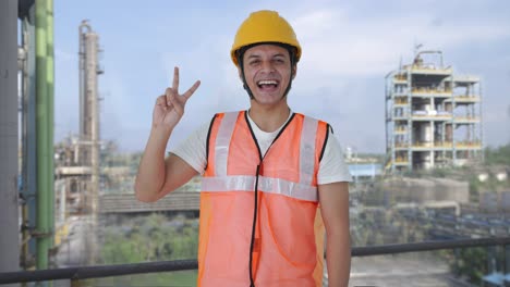 happy indian construction labour showing victory sign