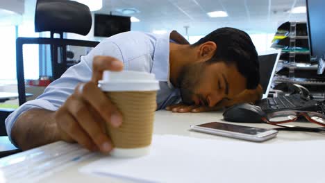 Male-executive-sleeping-at-desk