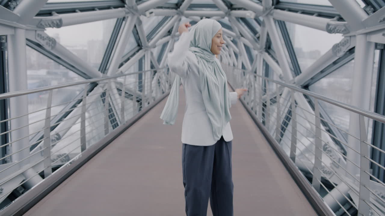 Happy Woman Dancing on a Modern Bridge