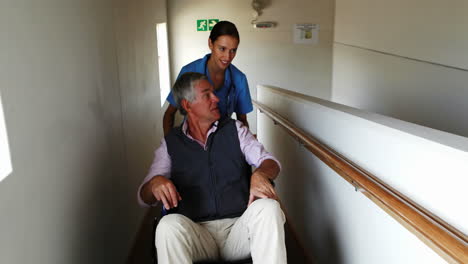 nurse pushing the senior mans wheelchair