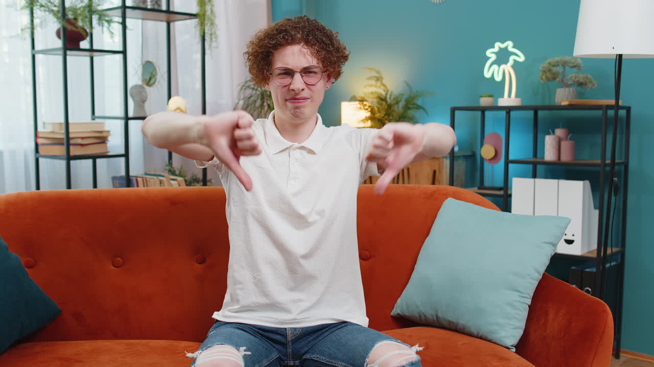 hombre infeliz molesto mostrando los pulgares hacia abajo disgusto gesto que expresa descontento desaprobación insatisfecho