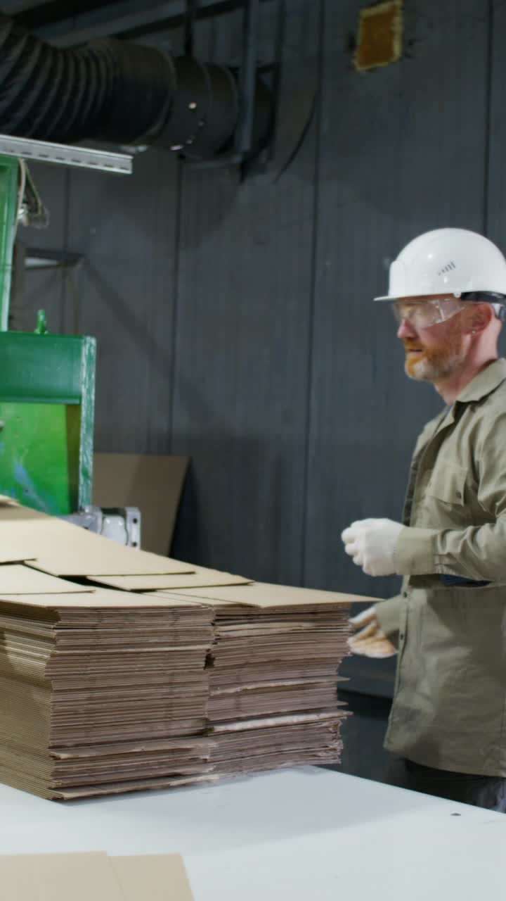 Worker in a Cardboard Box Production Facility