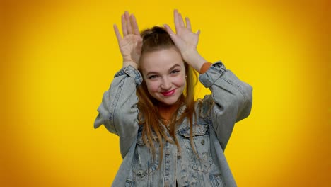 Lovely-funny-girl-smiling-friendly,-doing-bunny-ears-gesture-on-head-having-fun-fooling-comical-mood