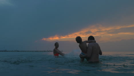 Happy-family-having-fun-with-splashing-water