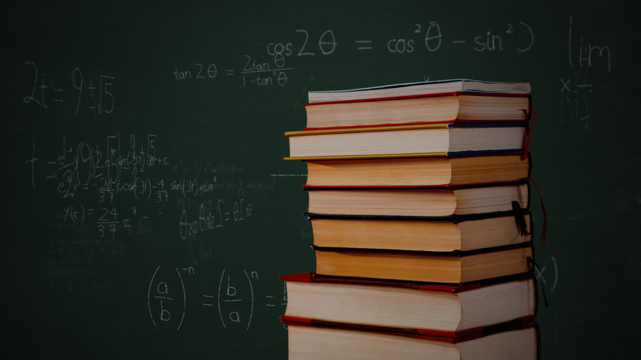 Tumpukan buku dan persamaan matematika serta grafik