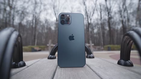 dark blue iphone on a park bench