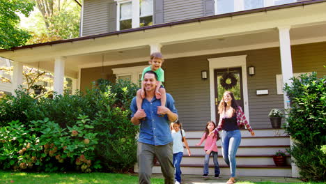 Father-Gives-Son-Ride-On-Shoulders-As-Family-Leave-House