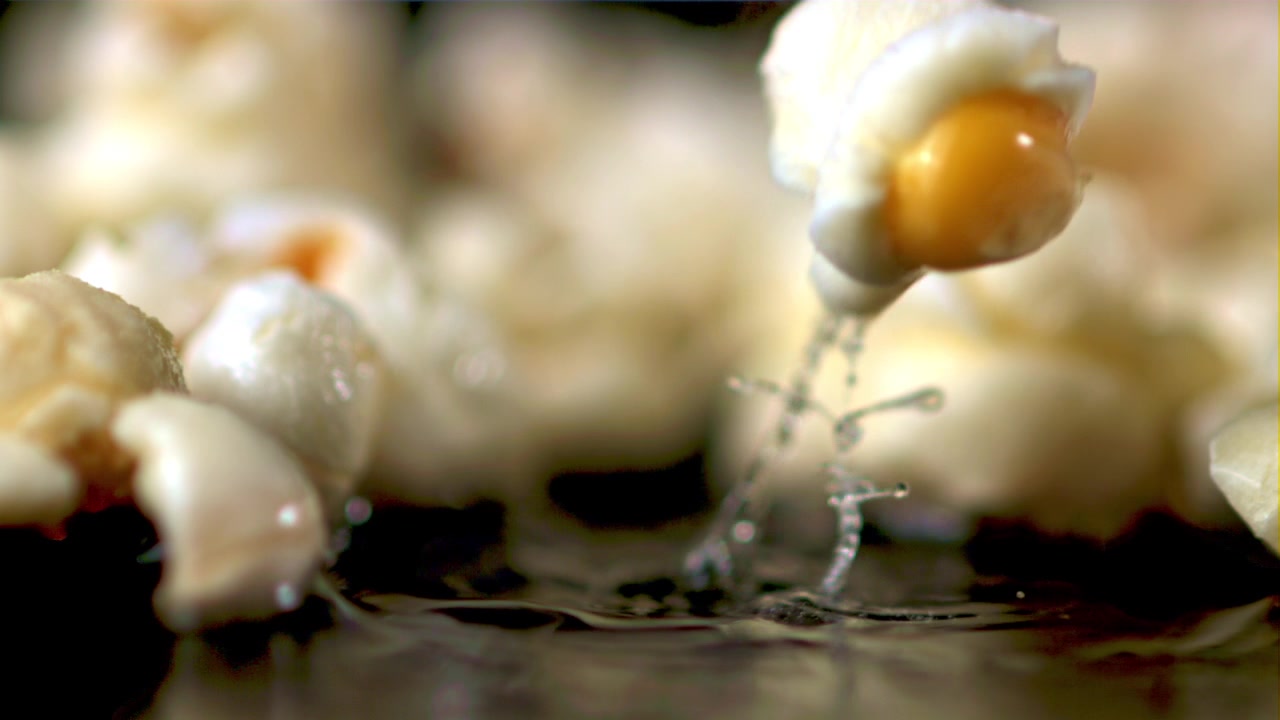 Close-up Slow Motion of a Popcorn Kernel Popping in Hot Oil