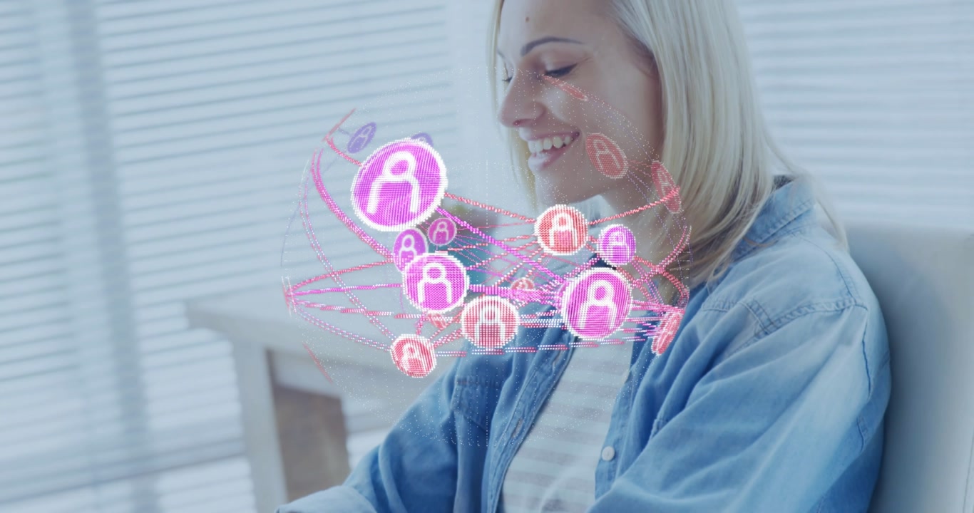 Woman typing on laptop, initiating glowing icon network rotating around torso in technology