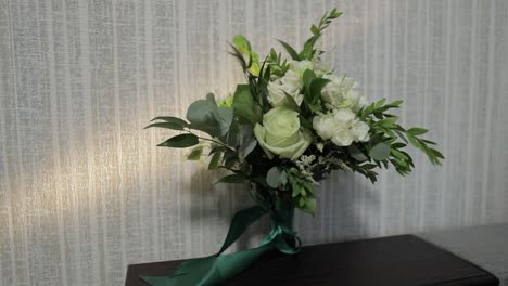 white wedding bouquet with green ribbon