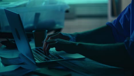 close up detail silhouette video of a detective policeman sitting in the interrogation room working close up detail silhouette video of a detective policeman sitting in the interrogation room working on a laptop and studying the evidence true crime documentary creative content