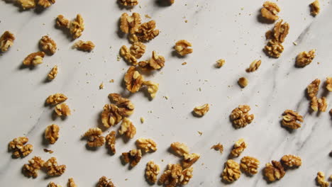 overhead shot of walnuts dropping onto marble surface shot in slow motion 1