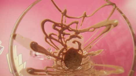 pouring mint ice cream inside a glass top view