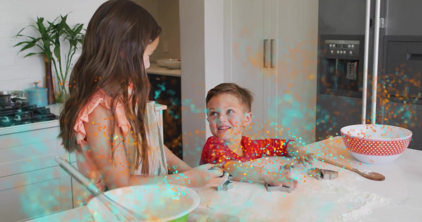 Sister cutting stars in dough and guiding brother in cooking as turquoise gold sparkling on hands