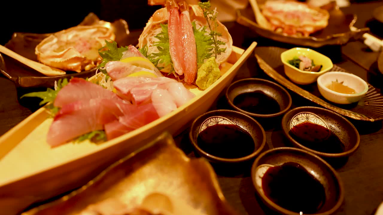 醤油と陶器の器が添えられた、伝統的な和食の海鮮盛り合わせのクローズアップショット