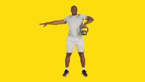 african man doing row exercises with one kettlebell