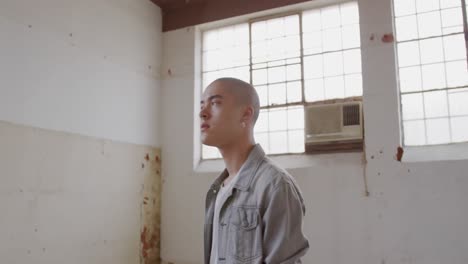 fashionable young man in an abandoned warehouse