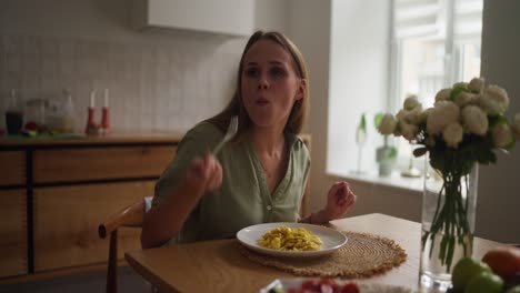 woman eating breakfast in kitchen