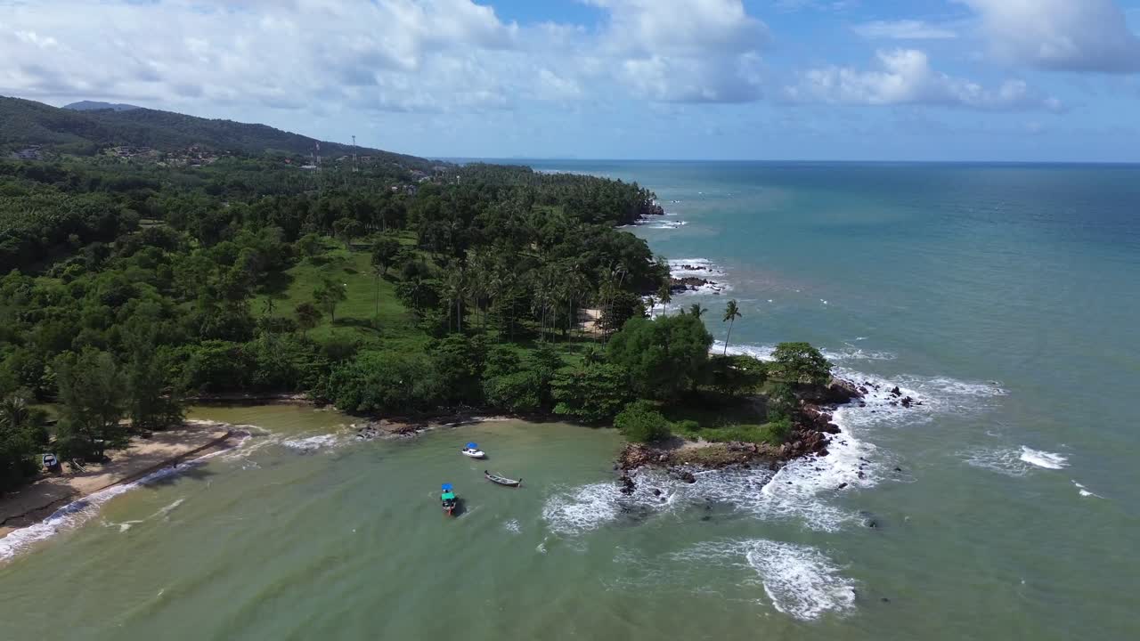 Low altitude drone footage gliding over Koh Lanta beach with turquoise water, golden sand and vast open sea horizon, highlighting tropical island beauty in southern Thailand