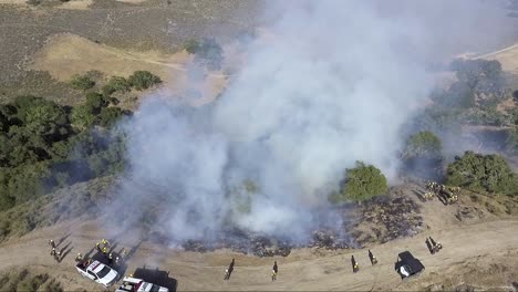 the contained fire slowly burns down the hill