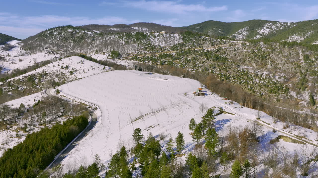 Aerial View of Snowy Mountain Vineyard Landscape in Winter
