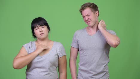 young multi-ethnic couple having neck pain together