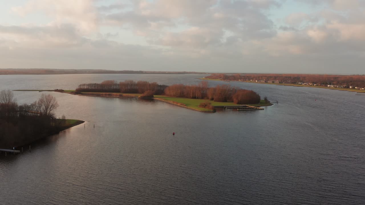 Small uninhabited island in the middle of the Veerse Meer lake. Drone shot