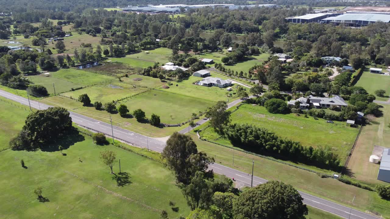 4K Aerial Video of a lush green rural suburb in Australia with large family homes
