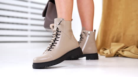 beige leather ankle boots on legs