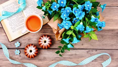 cozy reading with tea, flowers, and cupcakes