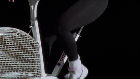 a young woman exercises on a stationary bike