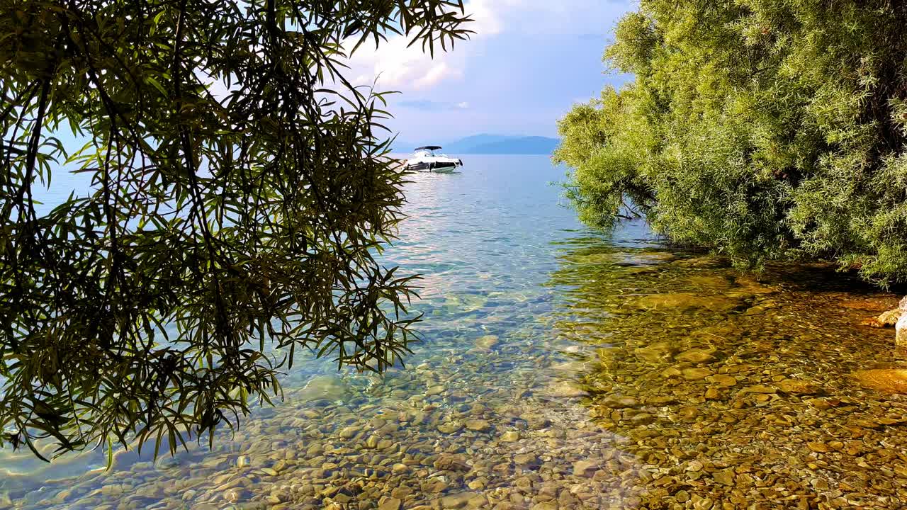 Truck shot revealing boat on blue water of Ohrid Lake in Macedonia