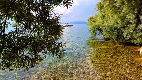 Disparo-De-Un-Camión-Que-Revela-Un-Barco-En-El-Agua-Azul-Del-Lago-Ohrid-En-Macedonia