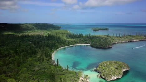 ascending aerial over kanumera bay and lush forest. new caledonia
