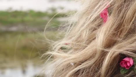 static view of flowers braided into a woman's long hair