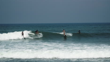 beach scene with surfers surfing waves in bali