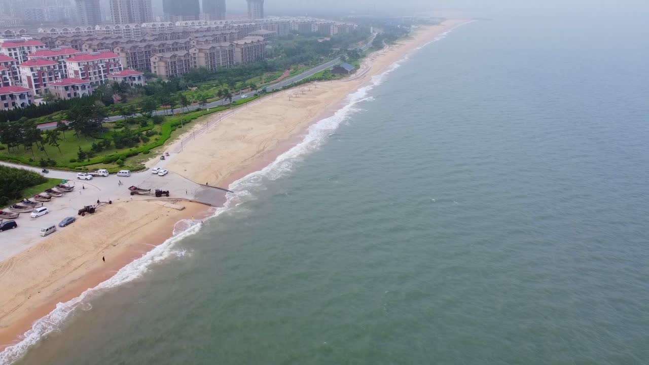 Tilt up shot of Nanhai beach and cityscape view, China