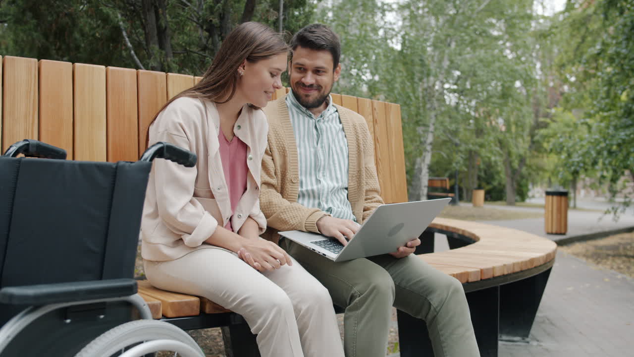 Couple Working on Laptop in Park