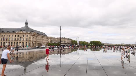 people enjoying the reflective water feature