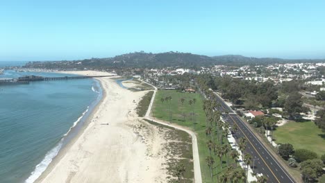 High-altitude-aerial-over-public-beach-and-state-park-on-the-beach-overseeing-Sterns-Wharf-in-Santa-Barbara,-California,-USA
