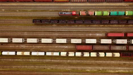 aerial view of colorful freight trains with goods on the railway station