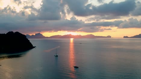 aerial wide shot of sunset at las cabanas beach, el nido, palawan, philippines