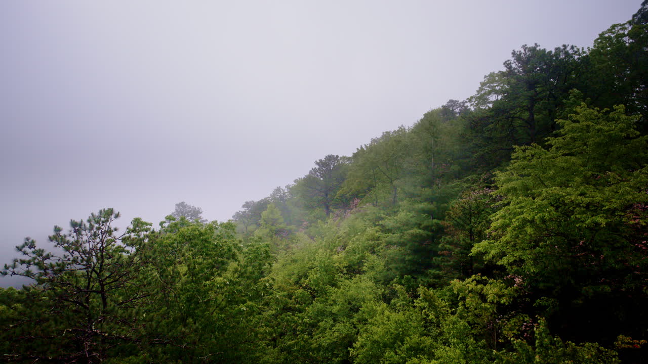 Cinematic drone capture of mist creeping over ridges