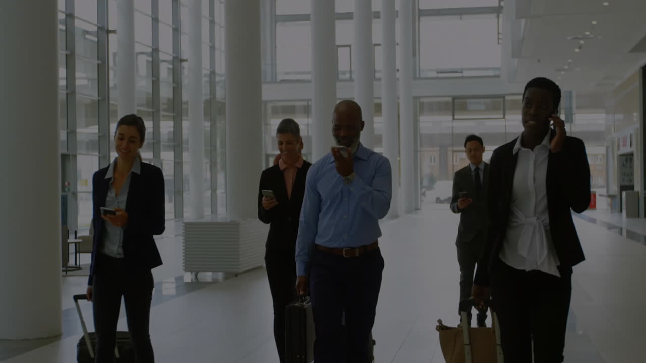 Animation of network of connections with people icons over diverse business people at airport